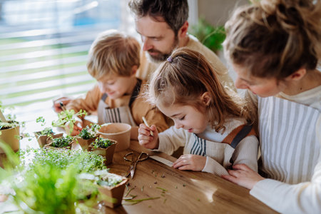 Happy family planting herbs together at spring.の写真素材