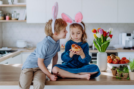 Little siblings enjoying easter time together in home.の写真素材
