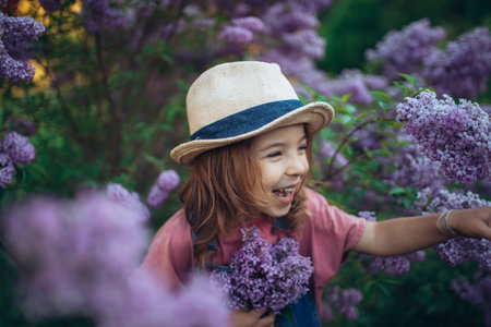 Portrait of little girl with lilac, spring mood.