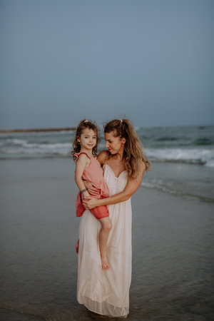Mother enjoying together time with her daughter at sea.の写真素材