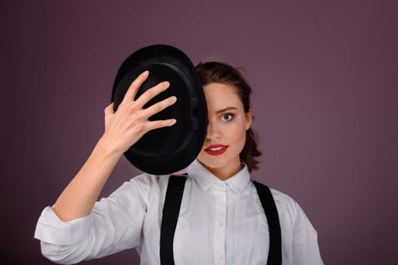 Portrait of happy young woman in hat, studio shoot.の写真素材
