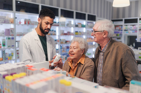 Young pharmacist helping senior couple to choos medication.の写真素材