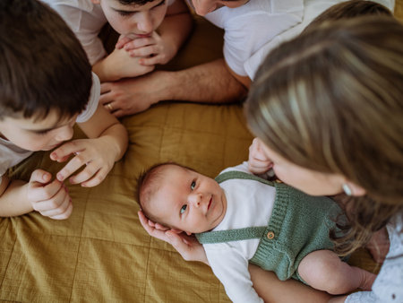 Big family with four kids enjoying their newborn baby.の写真素材