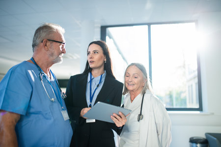 Young pharmaceutic seller explaining something to doctors in hospital.の写真素材