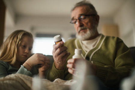 Senior man taking care of his sick granddaughter.の写真素材