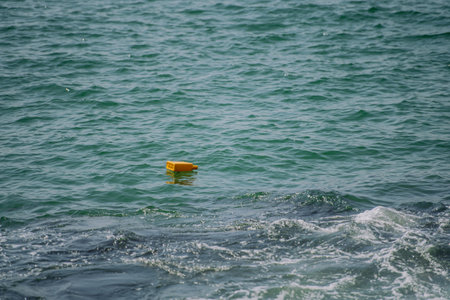 Close up of floating trash in sea.の写真素材