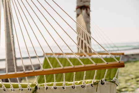 Close up of hammock hanging on the palms.の写真素材