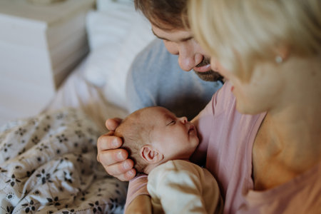 Close-up of parents cuddling their newborn baby.の写真素材