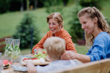 Multi generation family having outdoor garden party.の写真素材