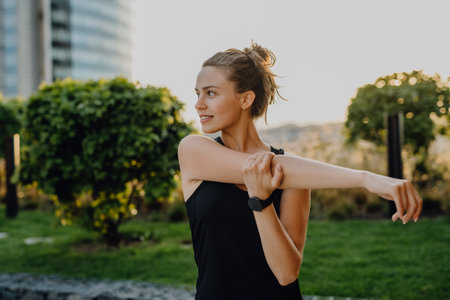 Young woman doing stretching in city, preparing for run, healthy lifestyle and sport concept.の写真素材