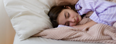 Close-up of teenage girl sleeping in her bed.の写真素材