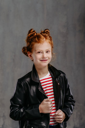 Portrait of little redhead girl with leather jacket.の写真素材