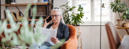 Portrait of senior businesswoman calling in her office.の写真素材