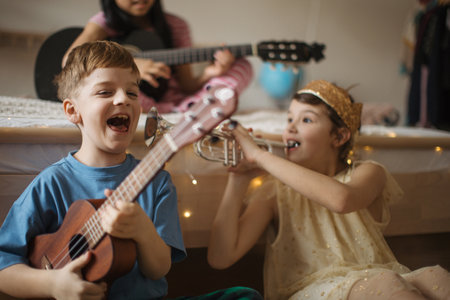 Happy three friends playing on a musical instuments.の写真素材