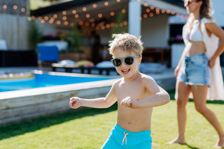 Little boy enjoying summer time with his mother on their backyard.の写真素材