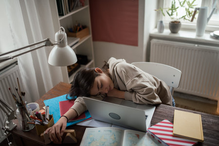 Young teenage girl studying in her room.