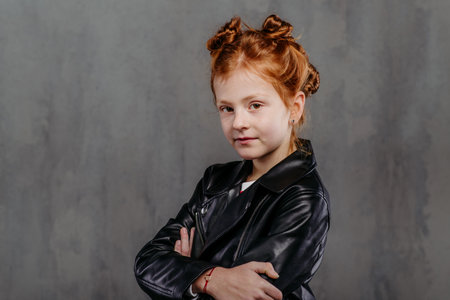Portrait of little redhead girl with leather jacket.
