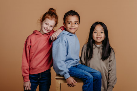 Portrait of three children, studio shoot. Concept of diversity in friendship.の写真素材