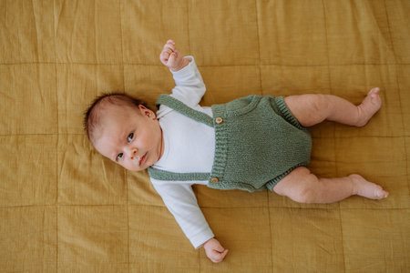 High angle view of sleeping baby in little bed.