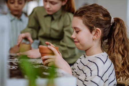 Happy children learning how to take care about plants.の写真素材