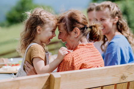 Rear view of happy family during outdoor garden party.