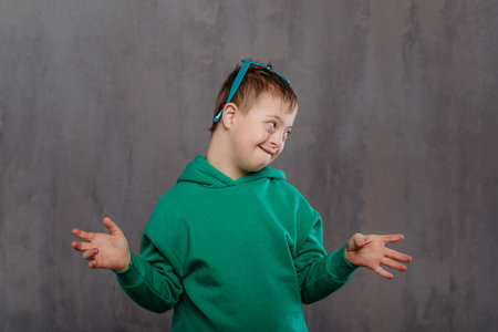 Funy portrait of little boy with down syndrome, studio shoot.の写真素材
