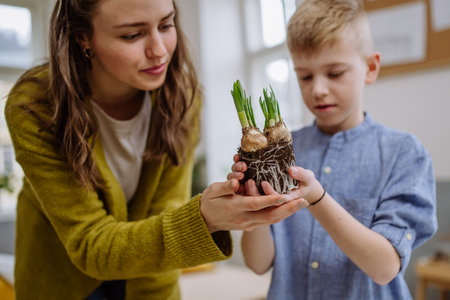 Young teacher learning child how to take care about plants.の写真素材