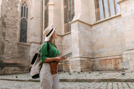 Young woman travel alone in old city centre. Wide photography.の写真素材