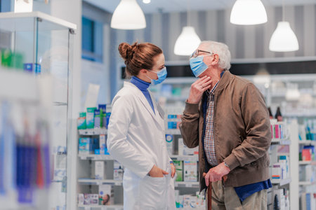 Young pharmacist helping senior man to choos medication.の写真素材
