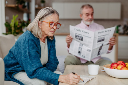 Senior couple spending leisure time together in their living room.の写真素材