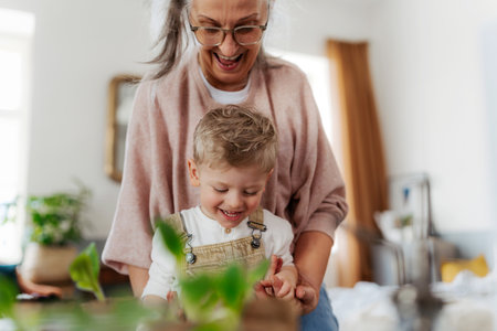 Grandmother with her grandson planting vegetables and flowers.の写真素材