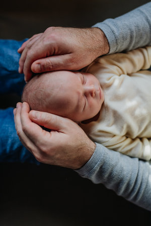 Close-up of father cudddling his little son.の写真素材