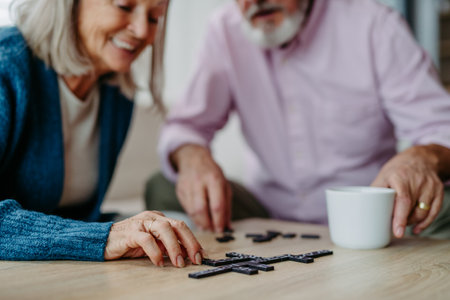 Senior couple playing dominoes game in their home.