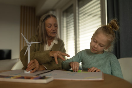 Senior man doing homework with his granddaughter.の写真素材