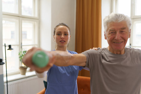 Young nurse doing exercise with senior man.の写真素材