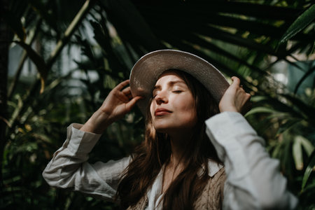 Portrait of young woman in botanical garden.の写真素材