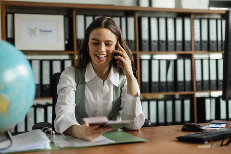 Young businesswoman working and calling in her office.の写真素材
