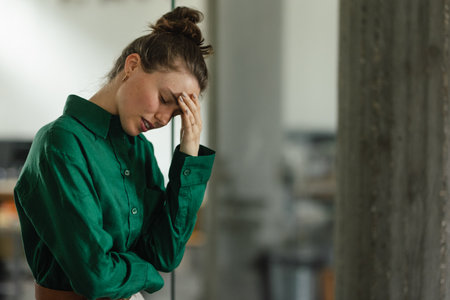 Young sad woman in office, having problem.