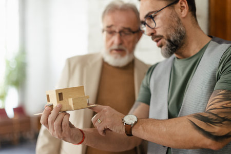 Young architects designing house for seniors client.の写真素材