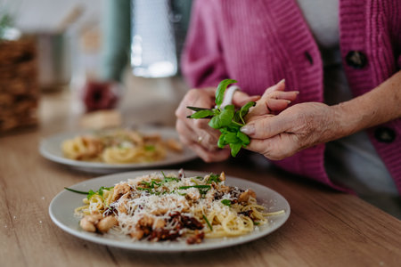 Cooking pasta with basil in the kitchen.