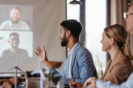 Young colleagues having meeting, consulting about green energy.の写真素材