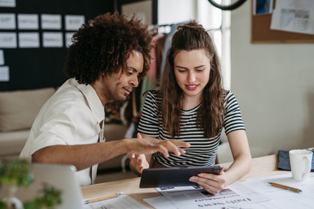 Young colleagues working together in startup company.