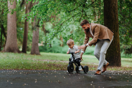 Single father with his little son spending together time in public park.の写真素材