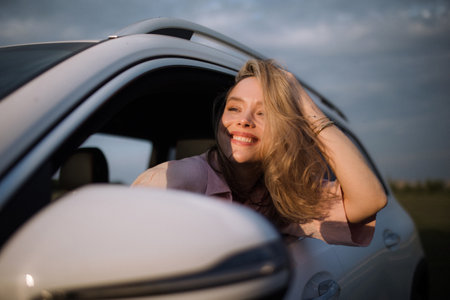 Happy woman driving her new electric car.
