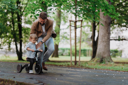 Single father with his little son spending together time in public park.の写真素材
