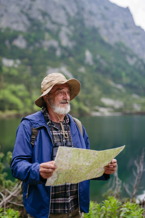 Potrait of active senior man hiking in autumn mountains.の写真素材