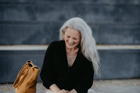 Portrait of a beautiful laughing woman in middle age with gray hair.の写真素材