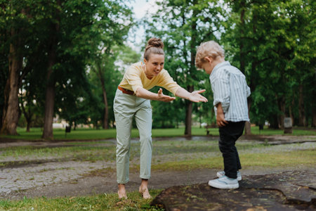 A little boy going to jump from tree stump in the park.の写真素材