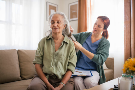 Nurse combing hair of beautiful senior woman.