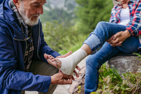 Senior woman injured her ankle during hike in the mountains.の写真素材